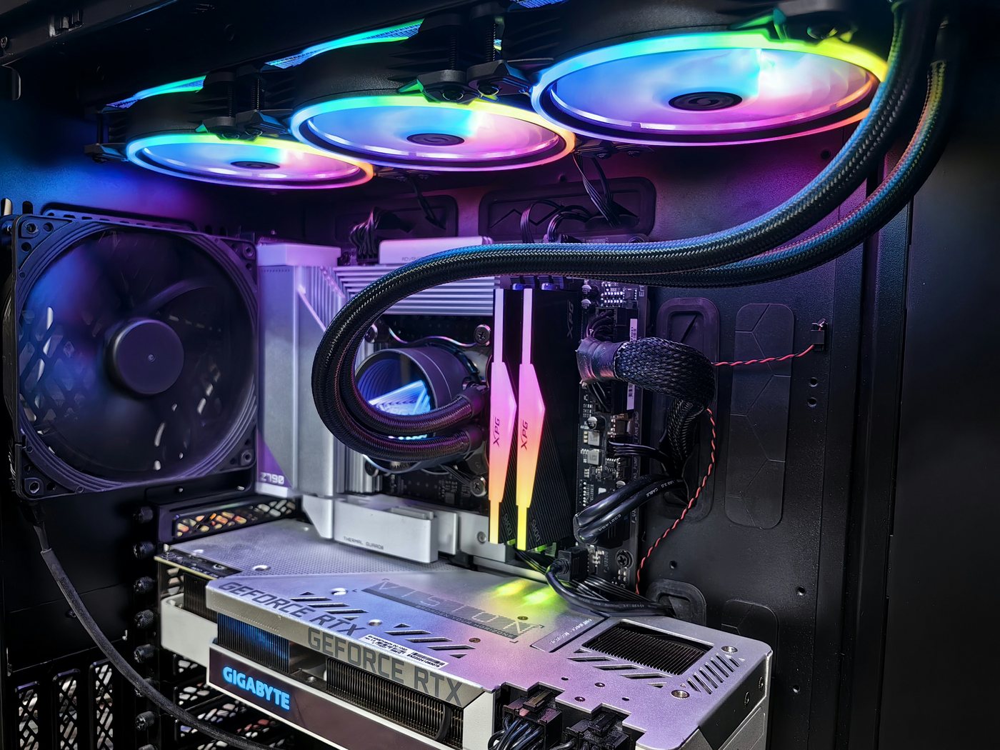Gaming PC components with cyan and pink lighting