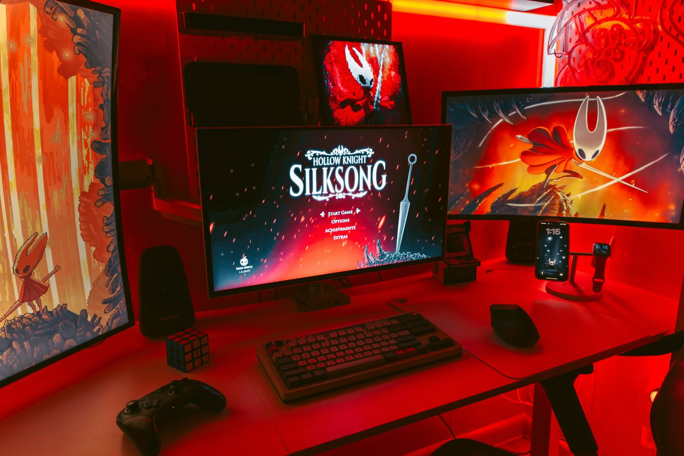 Gaming desk with red lighting and multiple monitors