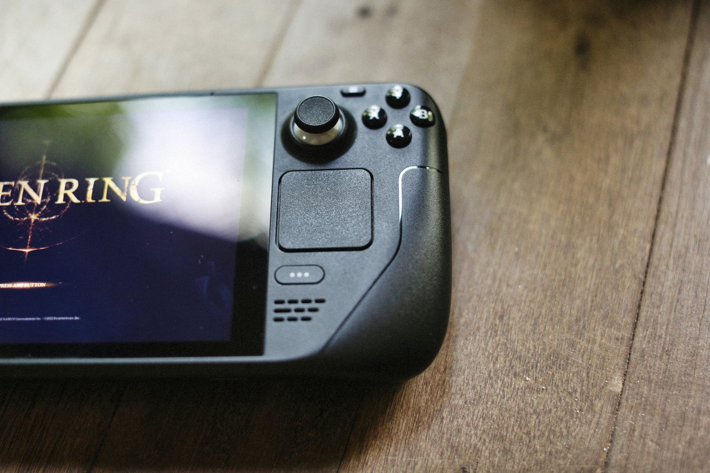 Steam Deck handheld on a wooden surface